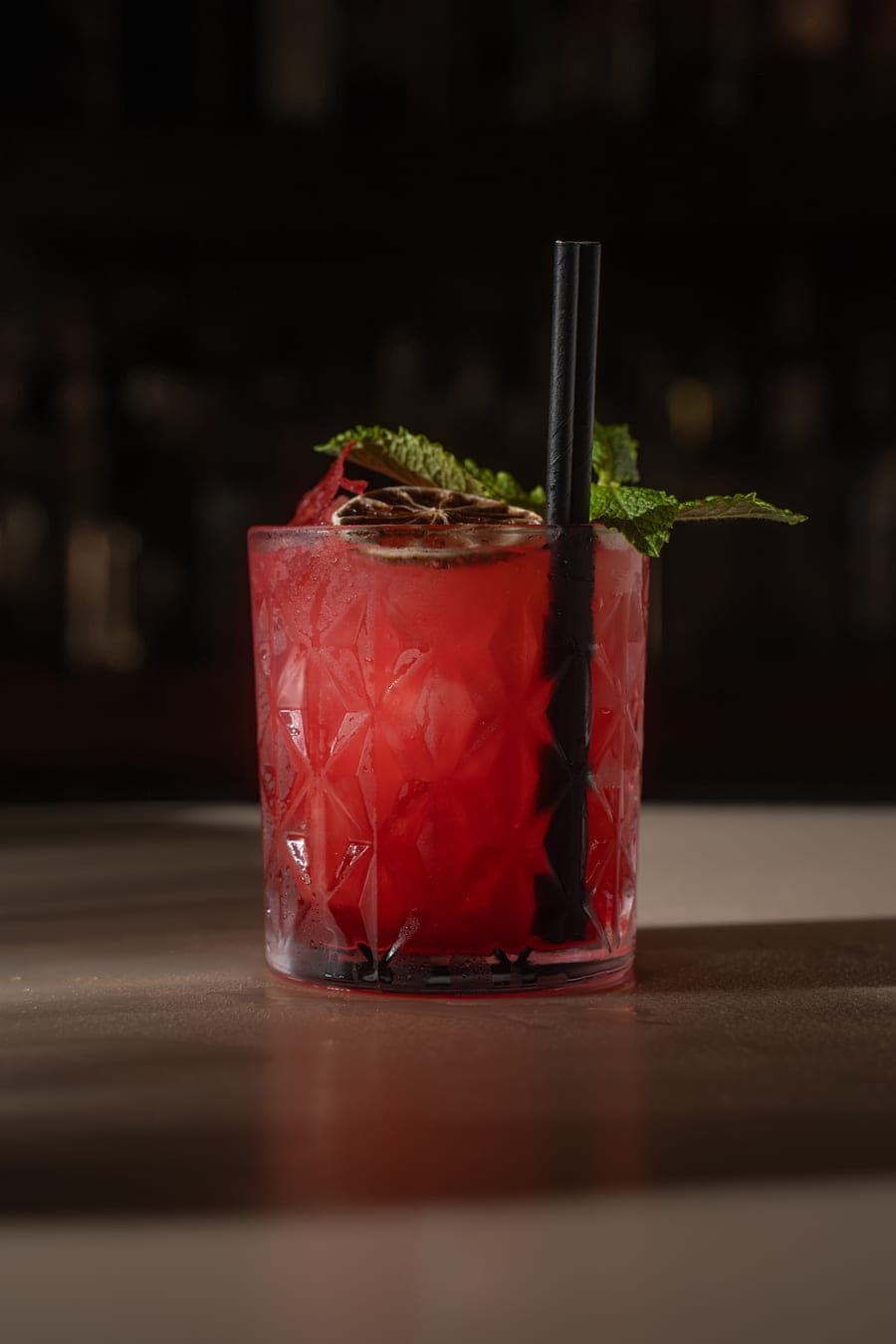 Red cocktail with mint and dried citrus at HOME Buckshaw